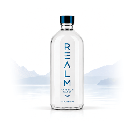 A REALM glass bottle